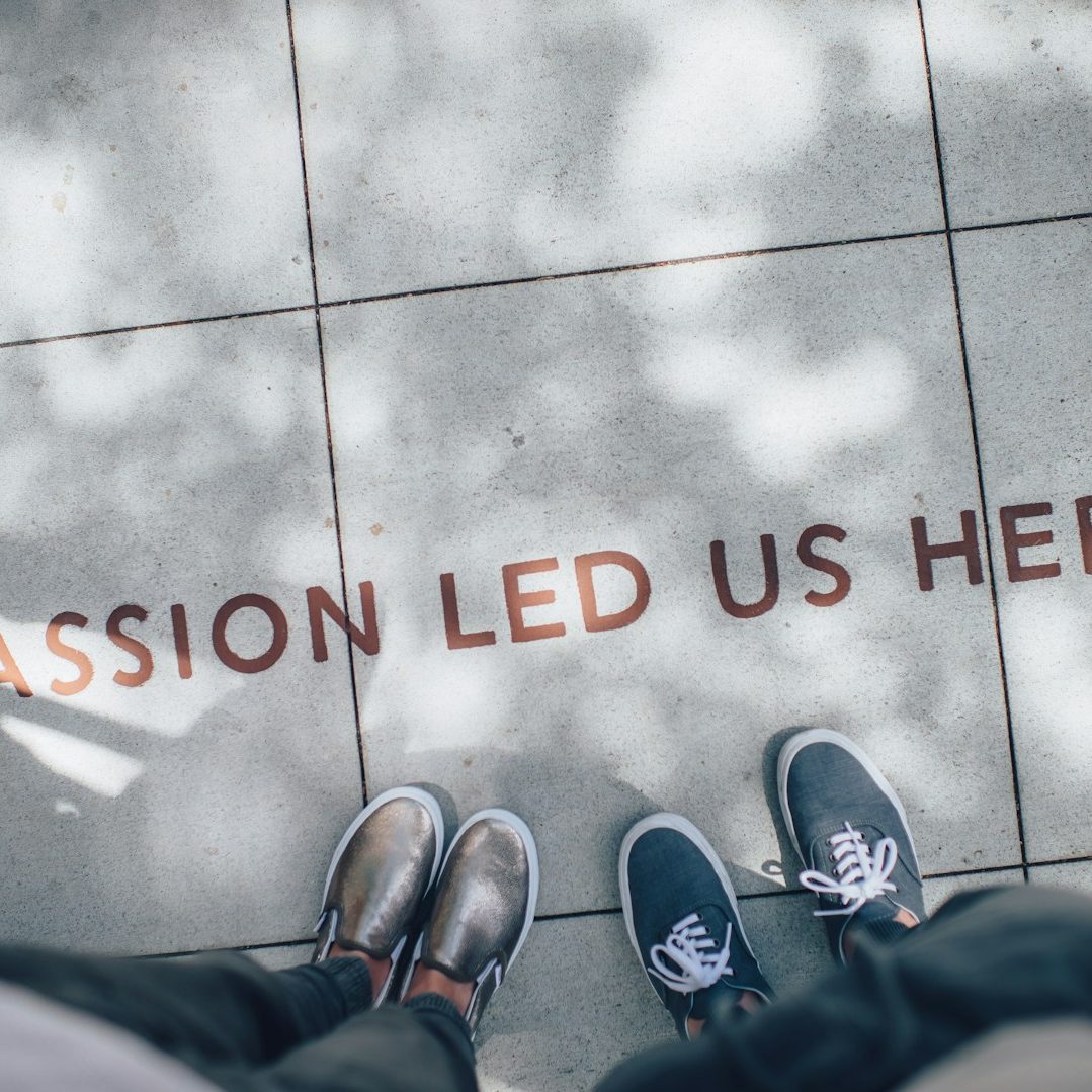 “Ready to Lead with Confidence” “Close-up of people standing side by side on a sidewalk, showing only their shoes, symbolizing readiness, unity, and confidence in leadershi
