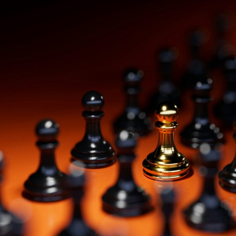 Bold Leadership Path logo on subscribe page” A single golden chess pawn surrounded by multiple black pawns.